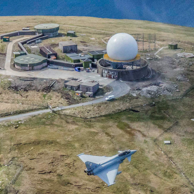Military jet fying past one of the Radome sites